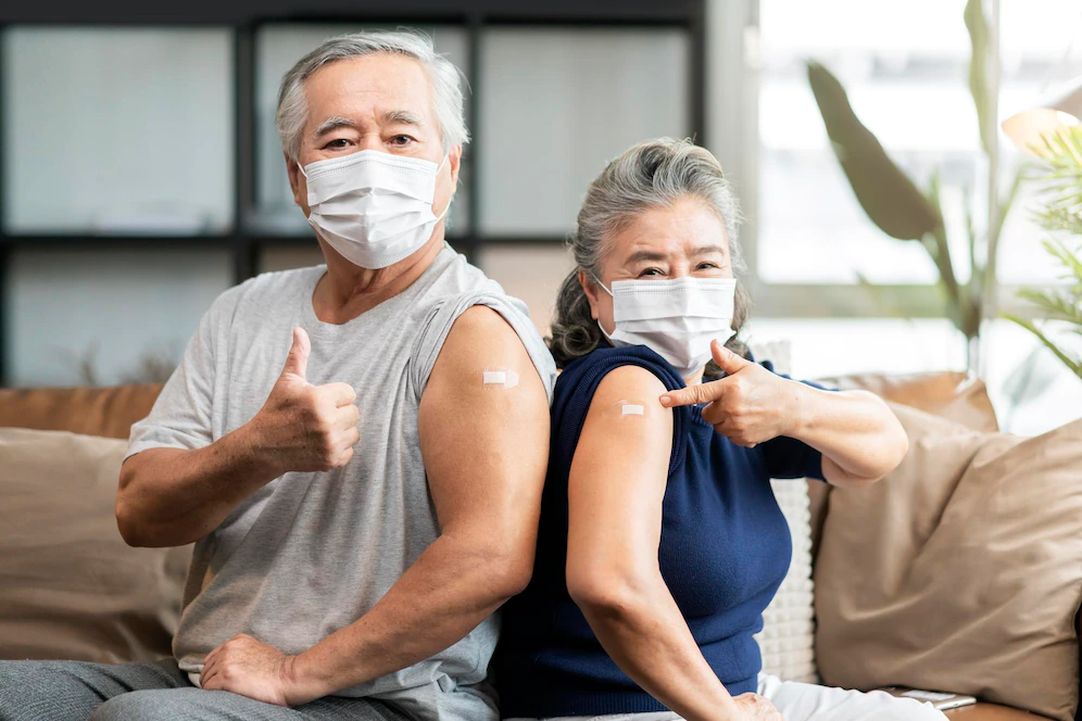 old asian senior couple wearing face mask virus protection happiness cheerful show bandage injection covid19 vaccinated with hand gesture point confident virus protection 609648 468