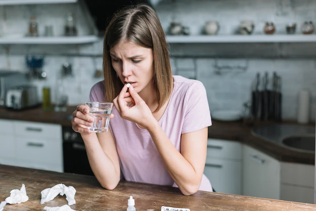 woman having fever taking medicine home 23 2147953192