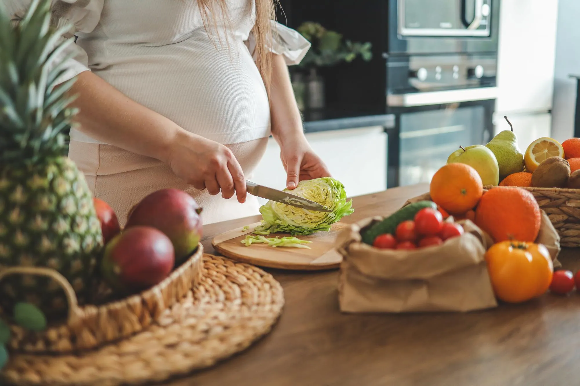 pregnant woman making salad her